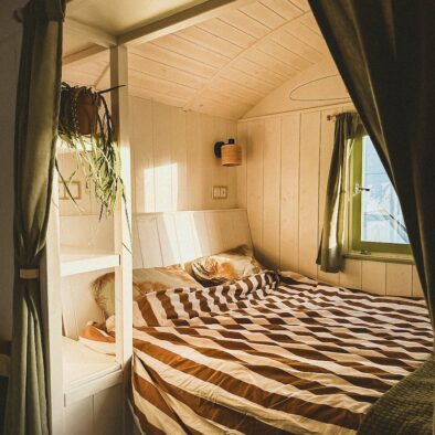 cosy bed area inside a shepherds hut